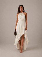 Elegante vestido de invitada de boda con cuello halter y bajo asimétrico de volantes